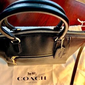 Coach New York from Bloomingdale’s. Used one time. Black leather, gold hardware